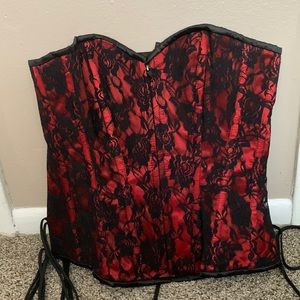 Large red corset with black lace. Zips in the front and ties in the back.